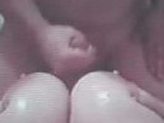 Busty baby gets her huge tits fucked. Fellow shoves his long cock between big boobs tightly gripped together.