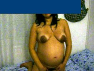 This pregnant wife with beautiful cinnamon skin is about 8 months pregnant. She shows her big belly and her breasts are exposed - her areolas are very dark and large.